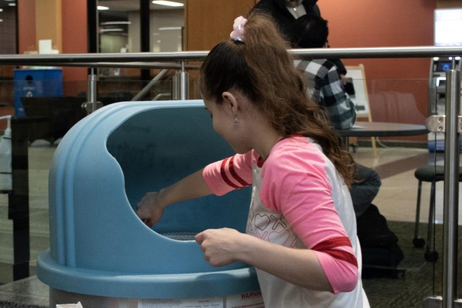 Smiles for Seniors event organizer Nadia Shaaban makes cotton candy in the Jobe Lounge on Feb. 7, 2023.