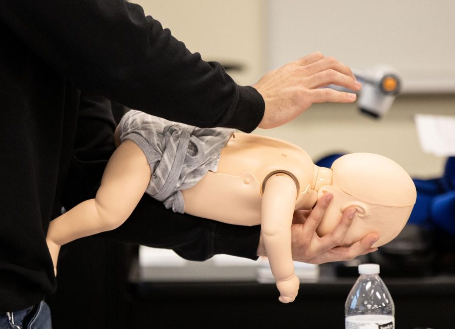 An EMT student practices the abdominal thrust maneuver on an infant manikin at the Elgin Community College Center for Emergency Services in Hampshire  on Thursday, Feb. 9, 2023. 
