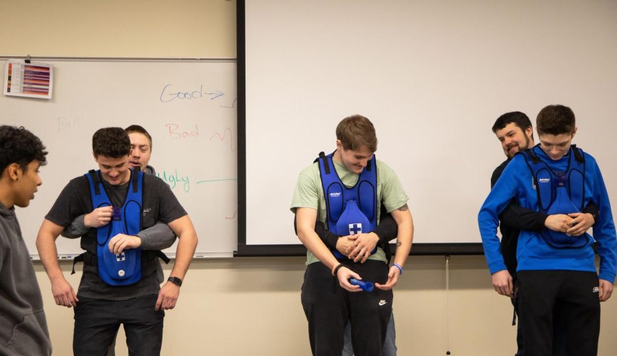 EMT students practice the abdominal thrust maneuver with their classmates at the Elgin Community College Center for Emergency Services in Hampshire on Thursday, Feb. 9, 2023. 