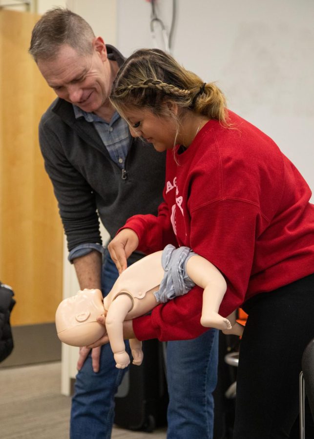 Instructor Dave Strossner teaches an EMT student how to administer the abdominal thrust maneuver on an infant manikin at the Elgin Community College Center for Emergency Services in Hampshire  on Thursday, Feb. 9, 2023. 