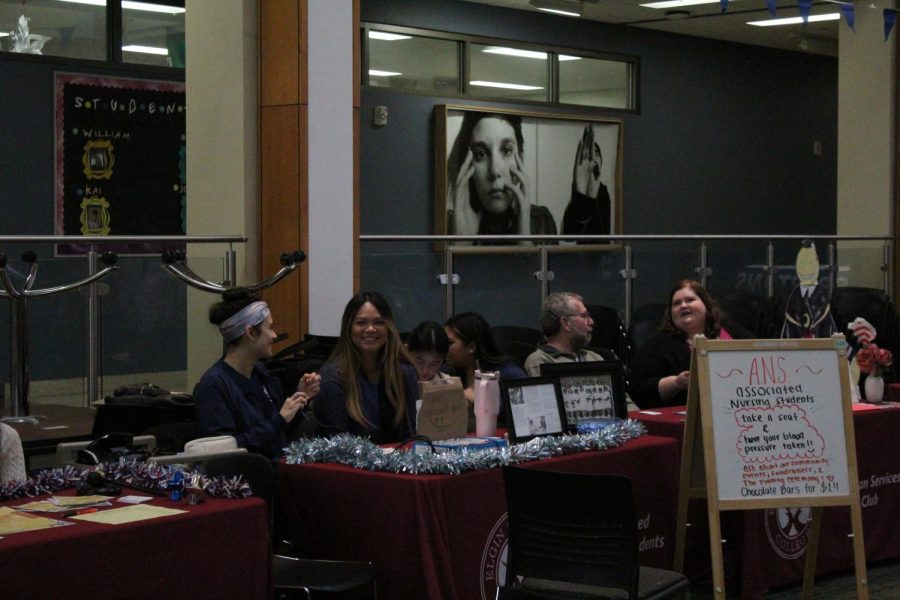 Associated Nursing Students and their members laugh at their booth during the Nacho Ordinary
Club Fair on Jan. 25th, 2023. 