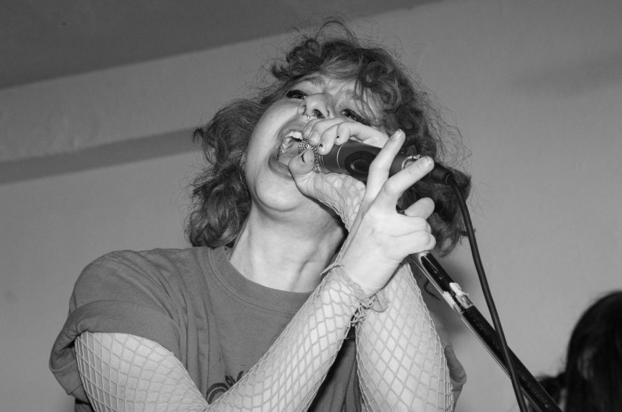 Lead singer of the band Ovarian Cystas, Ani, screams into the microphone at the Issue 003 Release Party on Feb. 11, 2023.