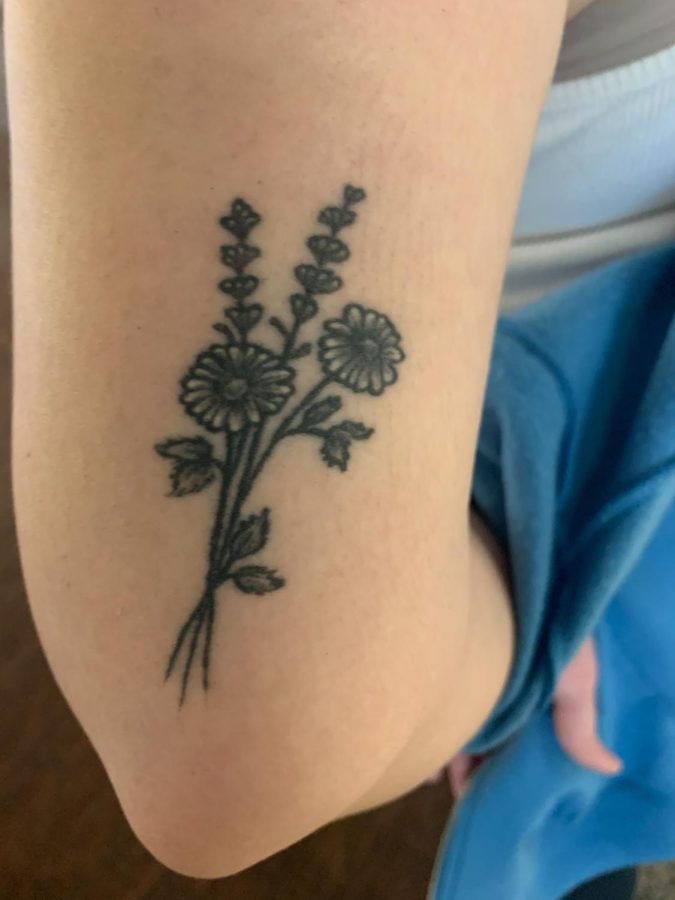 Second year ECC student Gianna Daufenbach reveals her flower tattoo, which was not only her first tattoo, but it also symbolizes her grandmothers favorite flower. Daufenbach, who was 17 when she got the tattoo, explained how her grandmother passed away when she was really young and how she felt really close to her, prompting her to get the artwork imprinted on her arm.