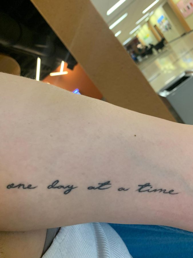 Second year ECC student Gianna Daufenbach reveals another one of her tattoos, which is a quote that reads, One day at a time. Due to struggling with anxiety and overthinking about the future, she got the tattoo to remind herself to take things one at a time. 