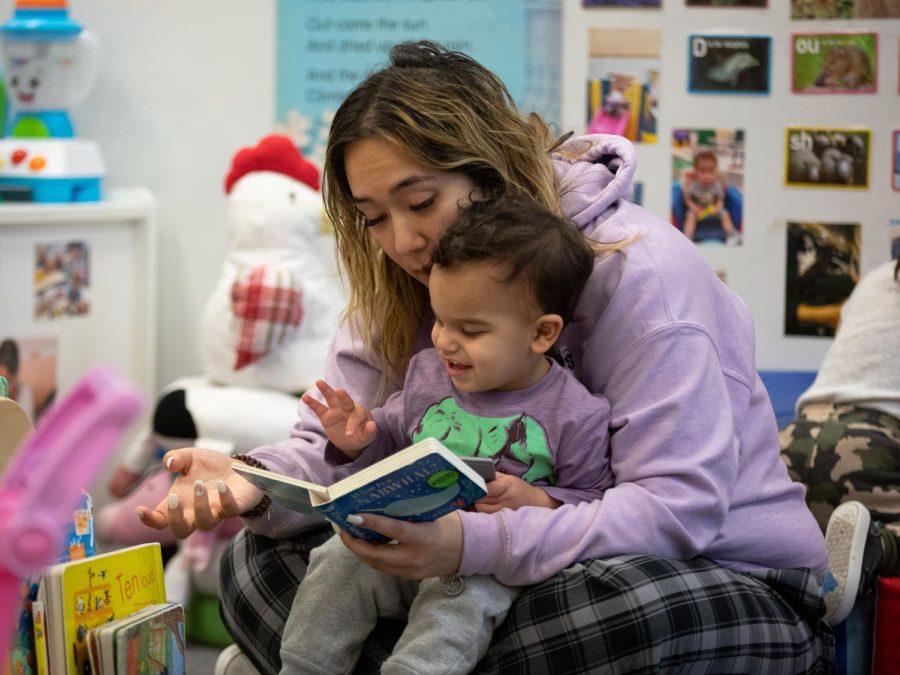 Briana Calandria reads to a toddler at ECCs Early Childhood Lab School on March 2, 2023. 