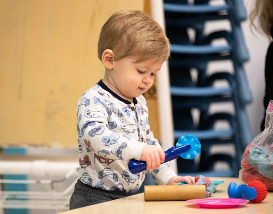 A toddler plays with Play-Doh during playtime at ECCs Early Childhood Lab School on March 2, 2023. 