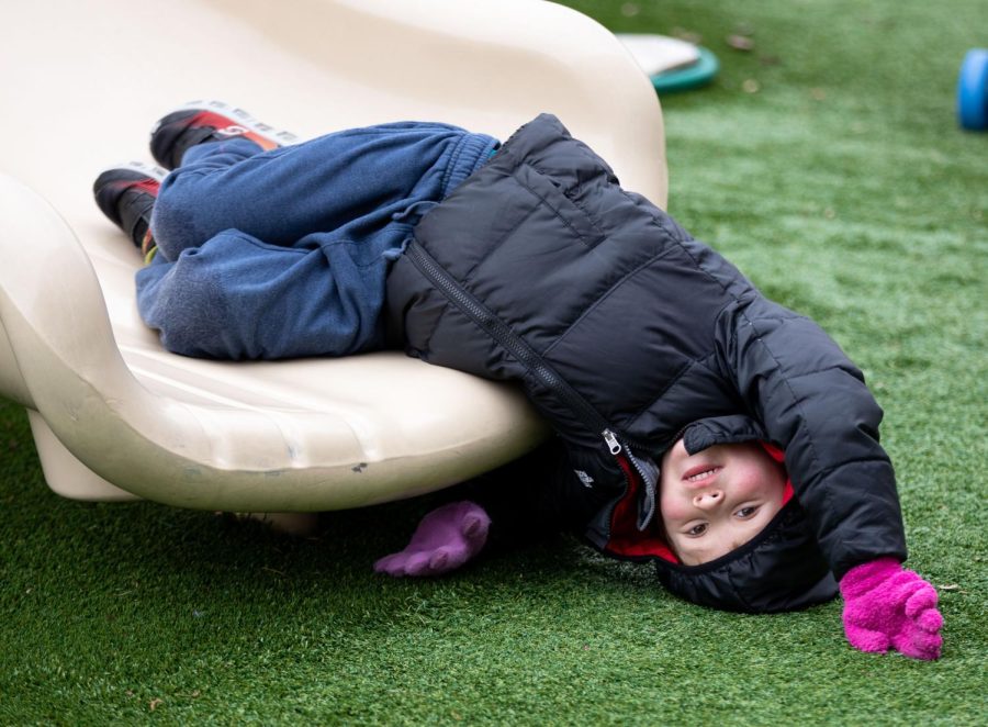 A Pre-K student lingers at the bottom of the slide during recess at ECCs Early Childhood Lab School on March 2, 2023. 