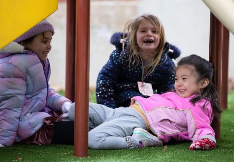 Pre-K students play and laugh underneath the playground during recess at ECCs Early Childhood Lab School on March 2, 2023. 