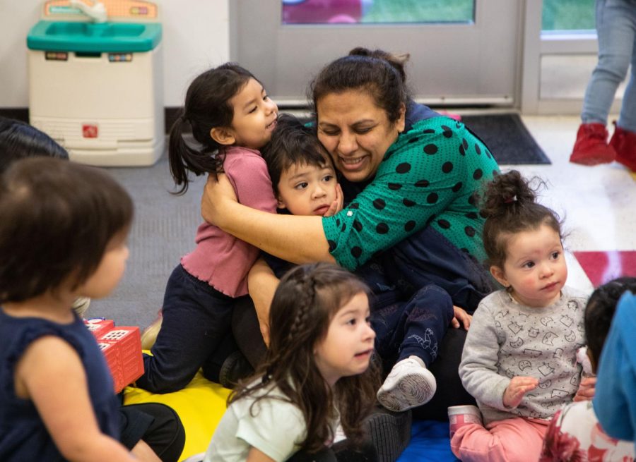 A teacher hugs two of the two year-olds at ECCs Early Childhood Lab School on March 2, 2023. 