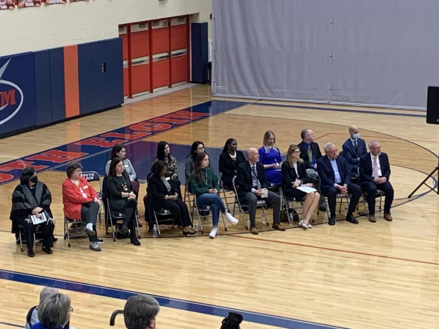 Dr. Tony Sanders and the Board of Education sitting while Rabbi Margaret Frisch Klein gives her opening remarks at Dr. Tony Sanders farewell celebration at South Elgin High School on Feb. 15, 2023.
