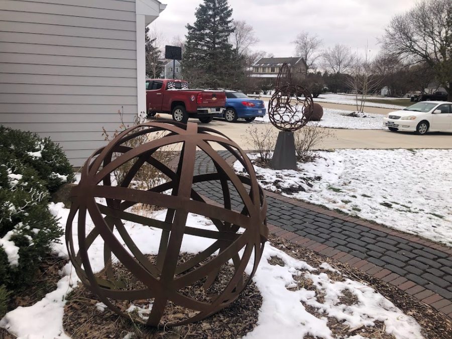 Sculptures created by Howard Russo are displayed in his front yard. 