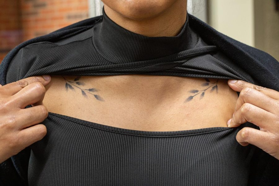 Professor of English Composition Sarah Bass showed off her Holly tattoo on Feb. 27, 2023. The two leaves of holly, both positioned parallel to each other on her collarbone, represent hope for her in light of tragic events that challenged her.