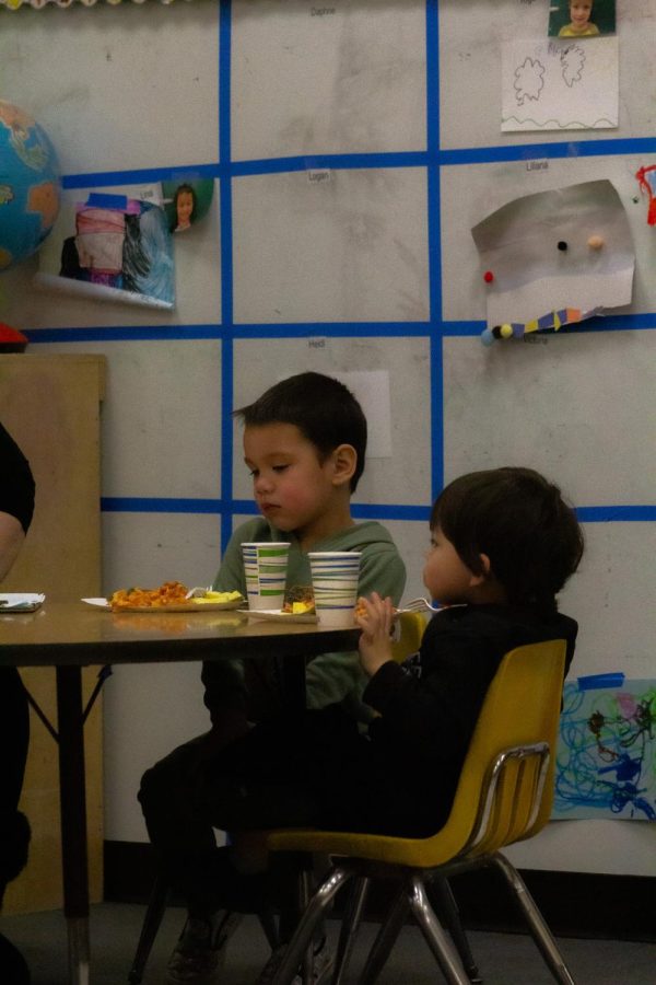 One of the kids working with the Early Development Staff and Students, while eating. Picture was taken on Mar. 2, 2023.