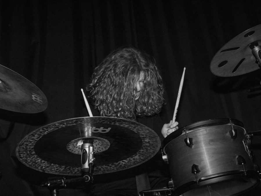 Weaver closes his eyes and pounds the drum kit  at the bands album release party in Chicago on March 3, 2023.