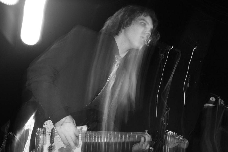 Holman plays his guitar while singing at the bands album release party in Chicago on March 3, 2023.
