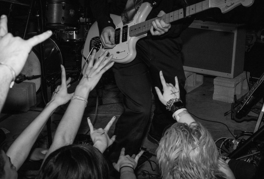 Eager fans reach their hands out toward Holman while he plays an energetic solo at the bands album release party in Chicago on March 3, 2023. 