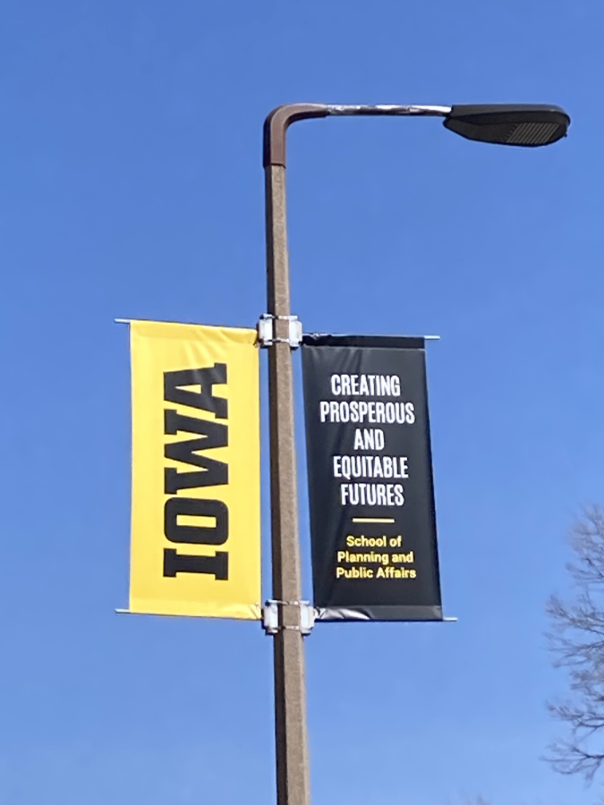A streetlight displaying a University of Iowa banner stands tall on North Madison Street in Iowa City on March 29, 2023.