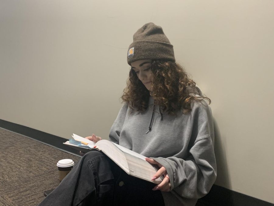 First-year student Mary Klikas reads from her Bible in Building M on May 8, 2023.