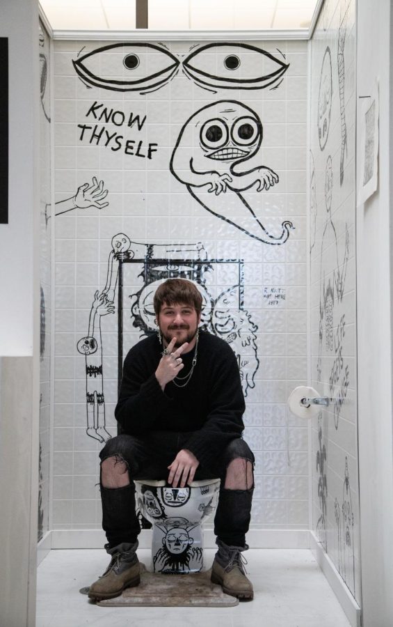 Artist and curator Josh Selvig sits in his exhibit, Fountain of Thought during the opening of exhibitions Artists at Play and Voices in the E. Max Von Isser Gallery on Wednesday, May 3, 2023