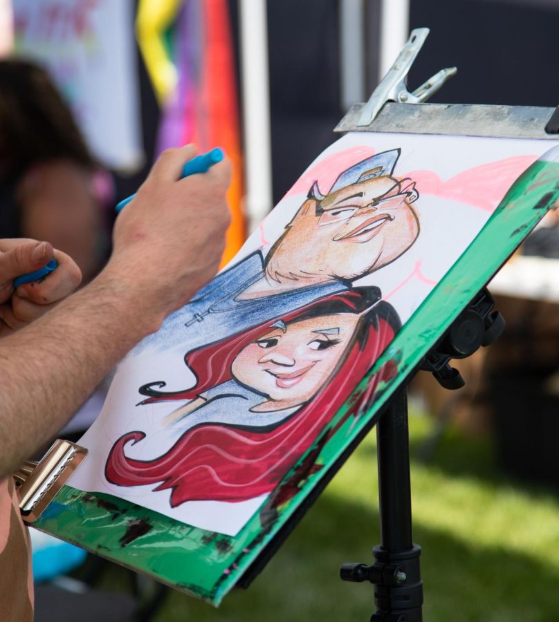 A caricature portrait of Tony Guajardo, and Isabel Escobar drawn by artist Tom Ryan of Chicago during Elgins Pride Festival at Festival Park in Elgin on Saturday, June 3, 2023. 