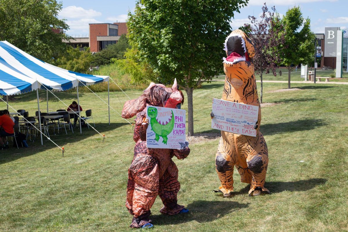 Students dressed in dinosaur costumes run around and promote Phi Theta Kappa and the new MyECC app during Clubchella on Aug. 30, 2023. 