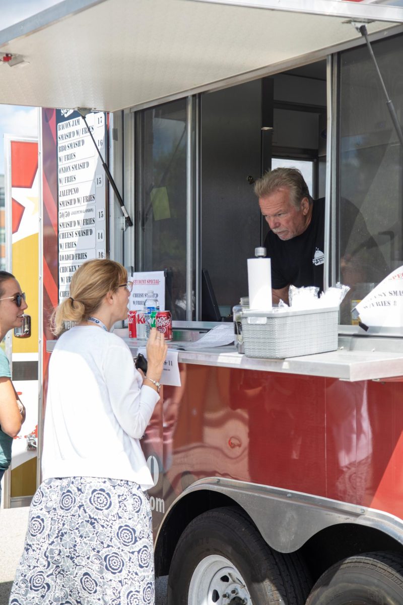An ECC faculty member orders food from the veteran-owned Smashd food truck during Clubchella on Aug. 30, 2023. 