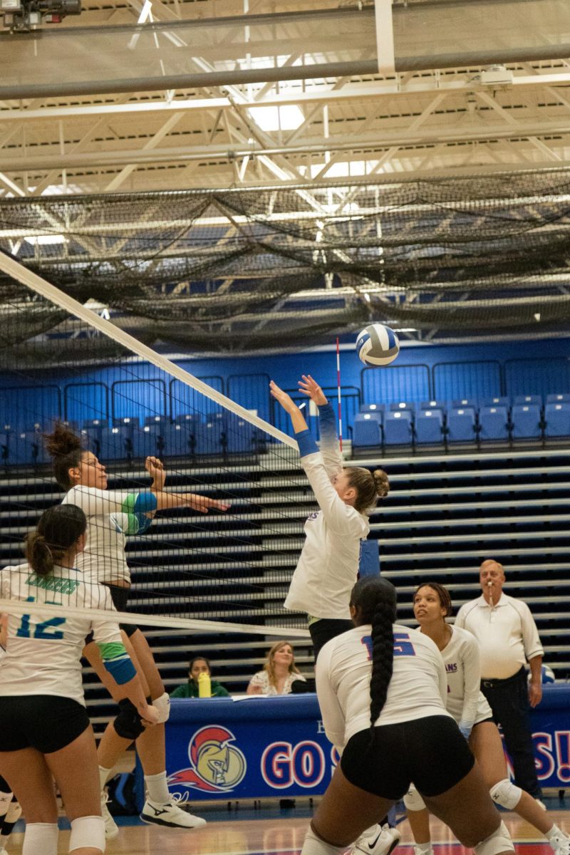FR. Courtney Consoer (8) jumps up to defend the net from a spike against College of Lake County on Sept. 27, 2023.