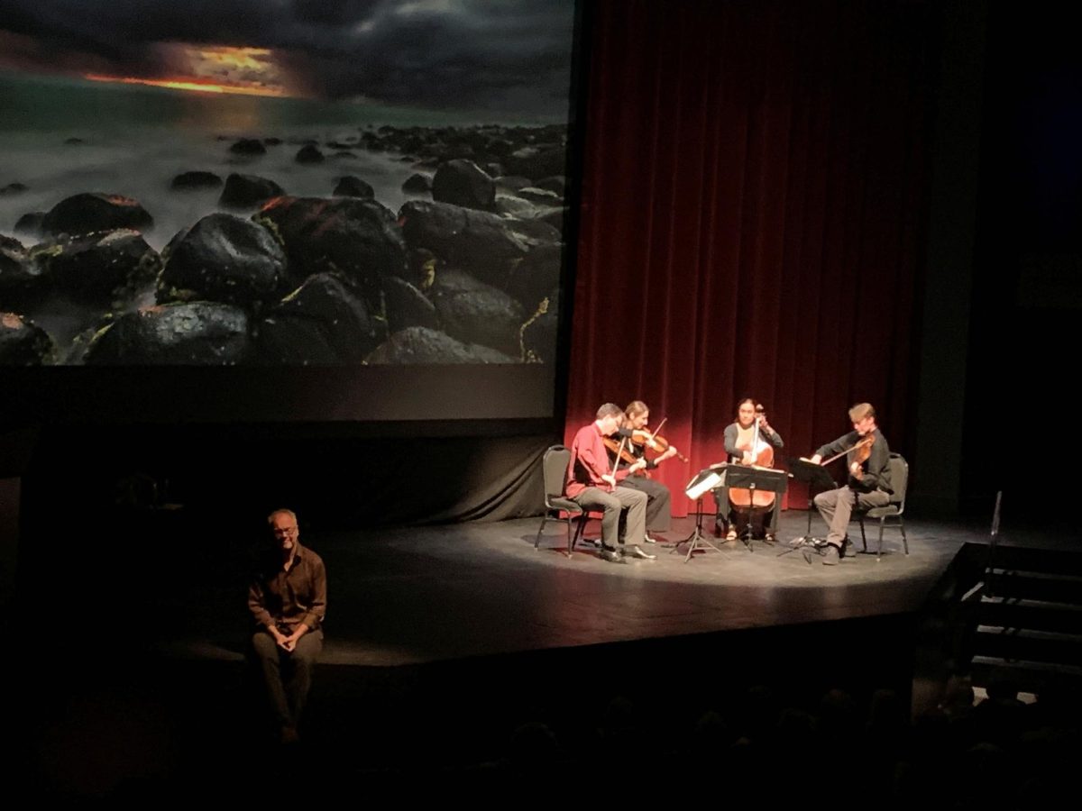 Robert Davies giving a lecture on stage while the Fry Street Quartet accompanied him with music during Rising Tide: The Crossroads Project at the Blizzard Theater on Oct 6, 2023.