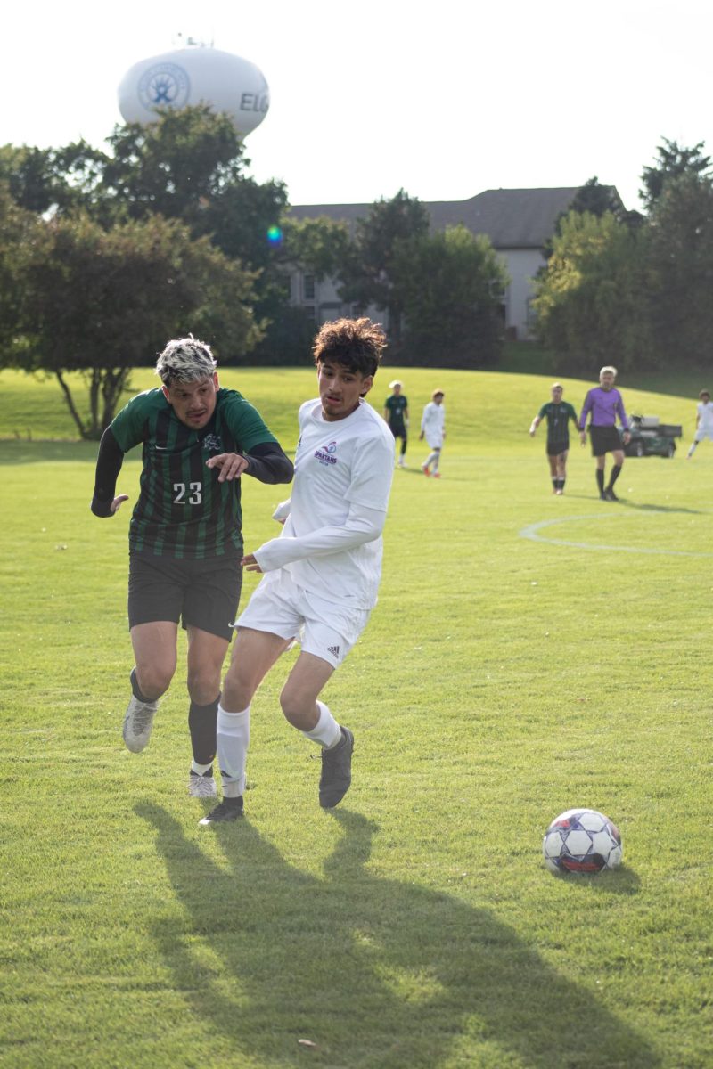 Diego Magana (3) drives towards the ball to beat the Prairie State College defender on Oct. 10, 2023.