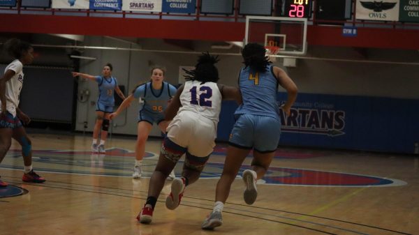 Fr. Zoey Wilson (12) pushing towards the hoop during their home game on Nov. 14, 2023.