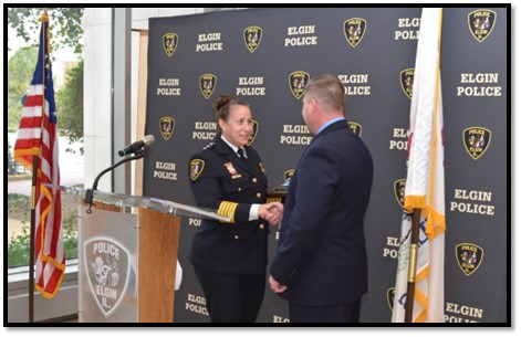 Elgin Police Chief Ana Lalley (left) congratulates Commander Kevin Senne (right) on his retirement at the Elgin Police Department on Oct. 6, 2023.