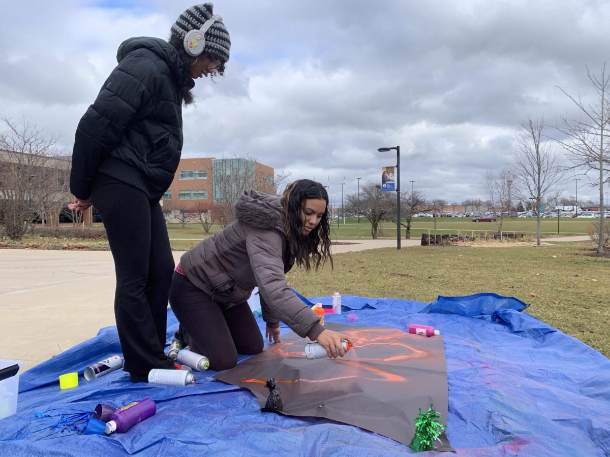 BSA members Mallory Woods (left) and Destiny Guevara (right) prepared for the All About Graf event by creating their own graffiti on Dec. 4.