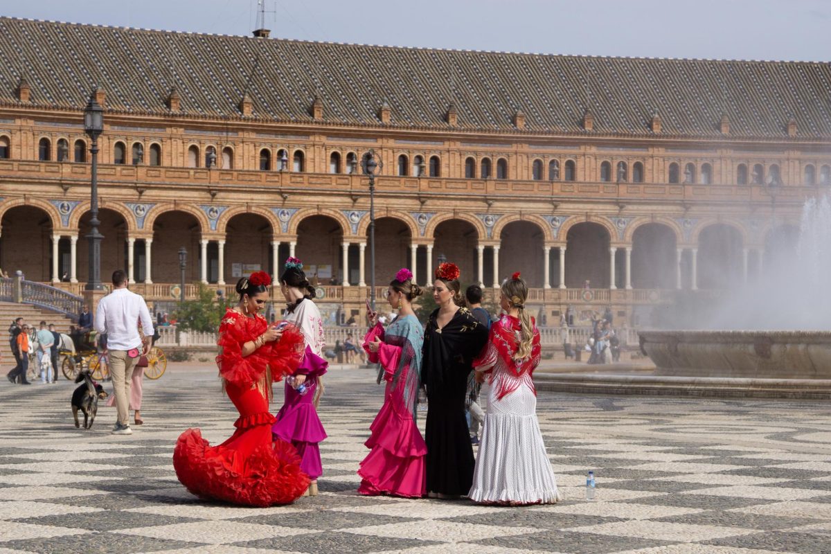 Flamencas take pictures at La Plaza de España before heading to the fair in Seville, Spain.