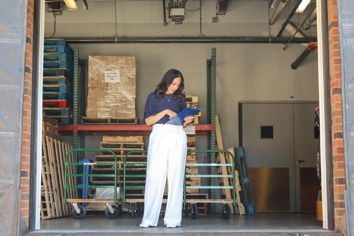 Gema Macklin, Director of Logistics, Records, and Asset Management, confirms incoming shipment at main loading dock.