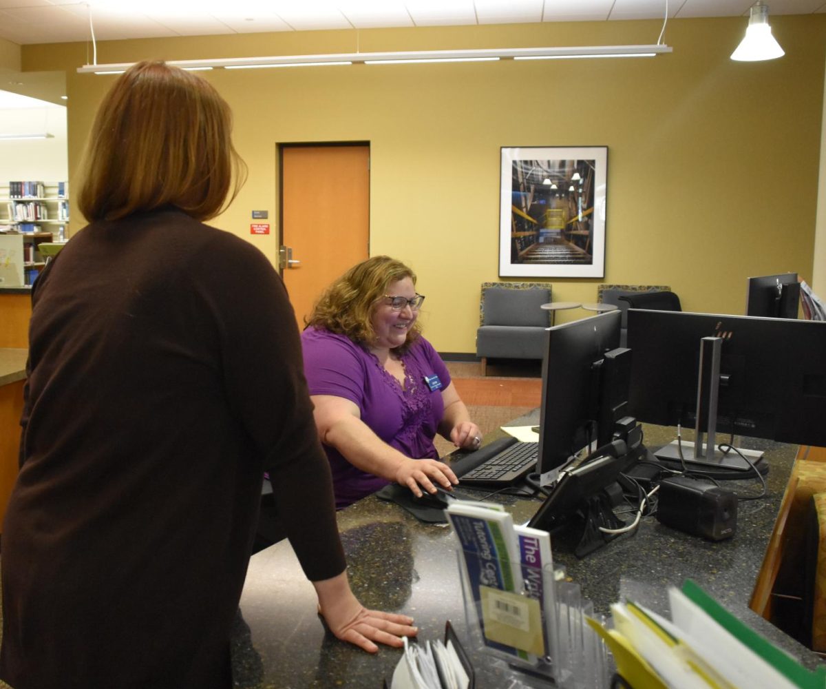Distance Learning Librarian, Stacey Shah, chats with a fellow ECC Library staff member.