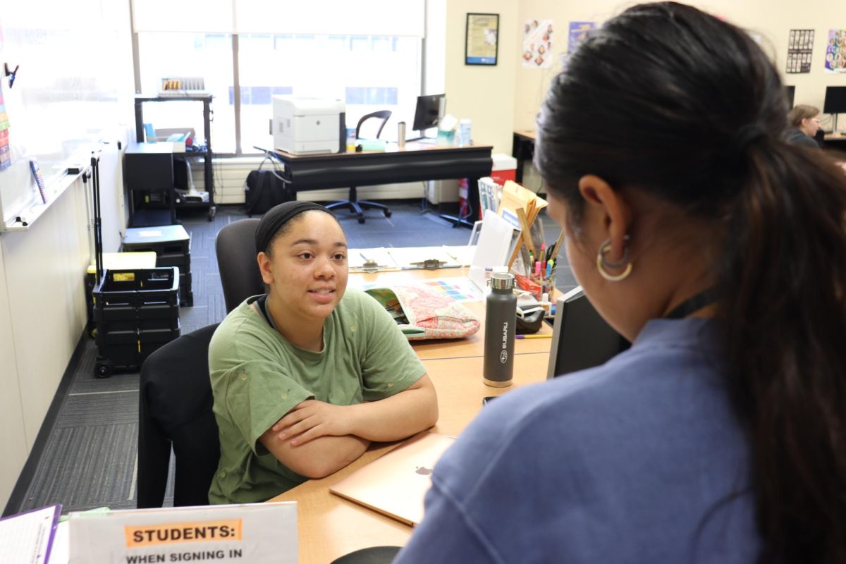 Fifth Semester ECC Arts Student Ava Johnson discusses how she does calculations on her mobile game with staff writer Viviana Avila.  Photo taken in the Math Lab D219