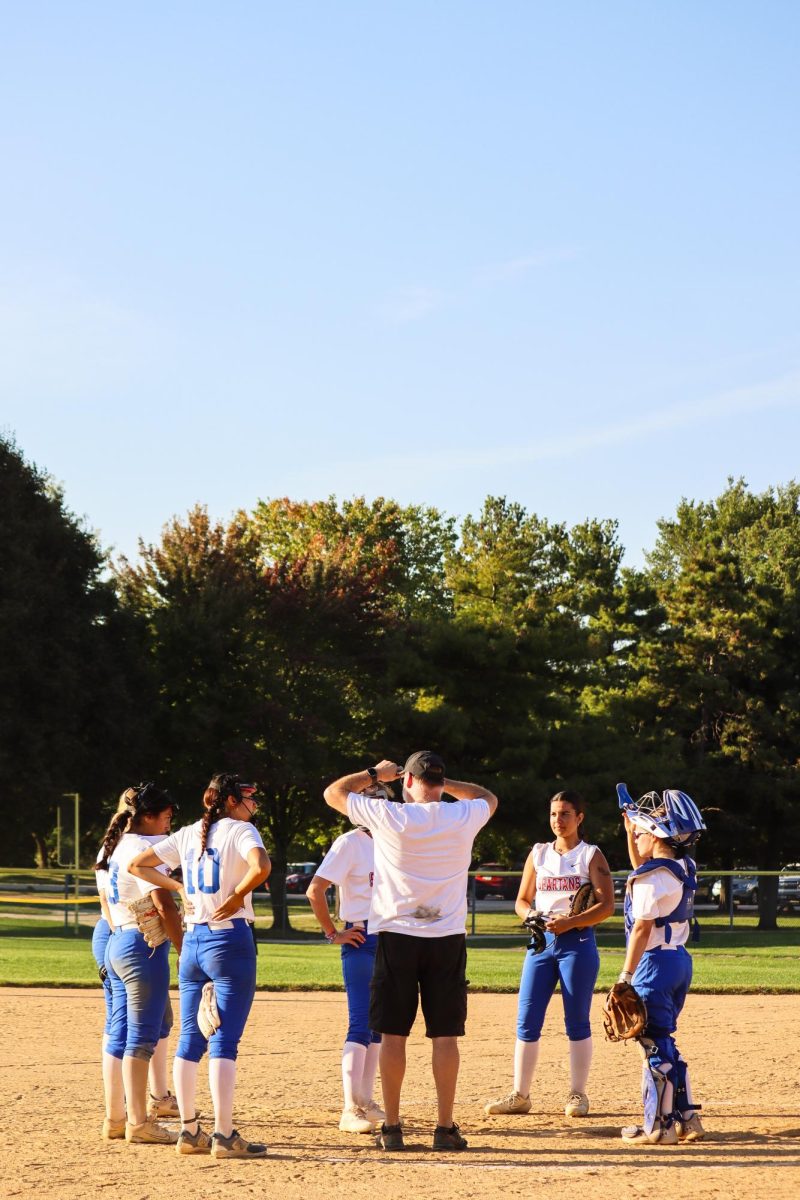 Elgin Spartans Softball team recollect between innings in a game against Harper College Hawks on September 17, 2025. This is the ECC Softball Program's second year with a team since being discontinued in 2022.