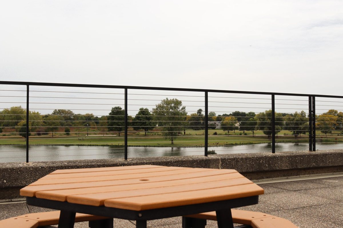 Hexagonal tables on the outer rooftop area of Building B, on September 19, 2025. The tables overlook the pond near the ECC campus and are accessible by indoor and outdoor stairs.