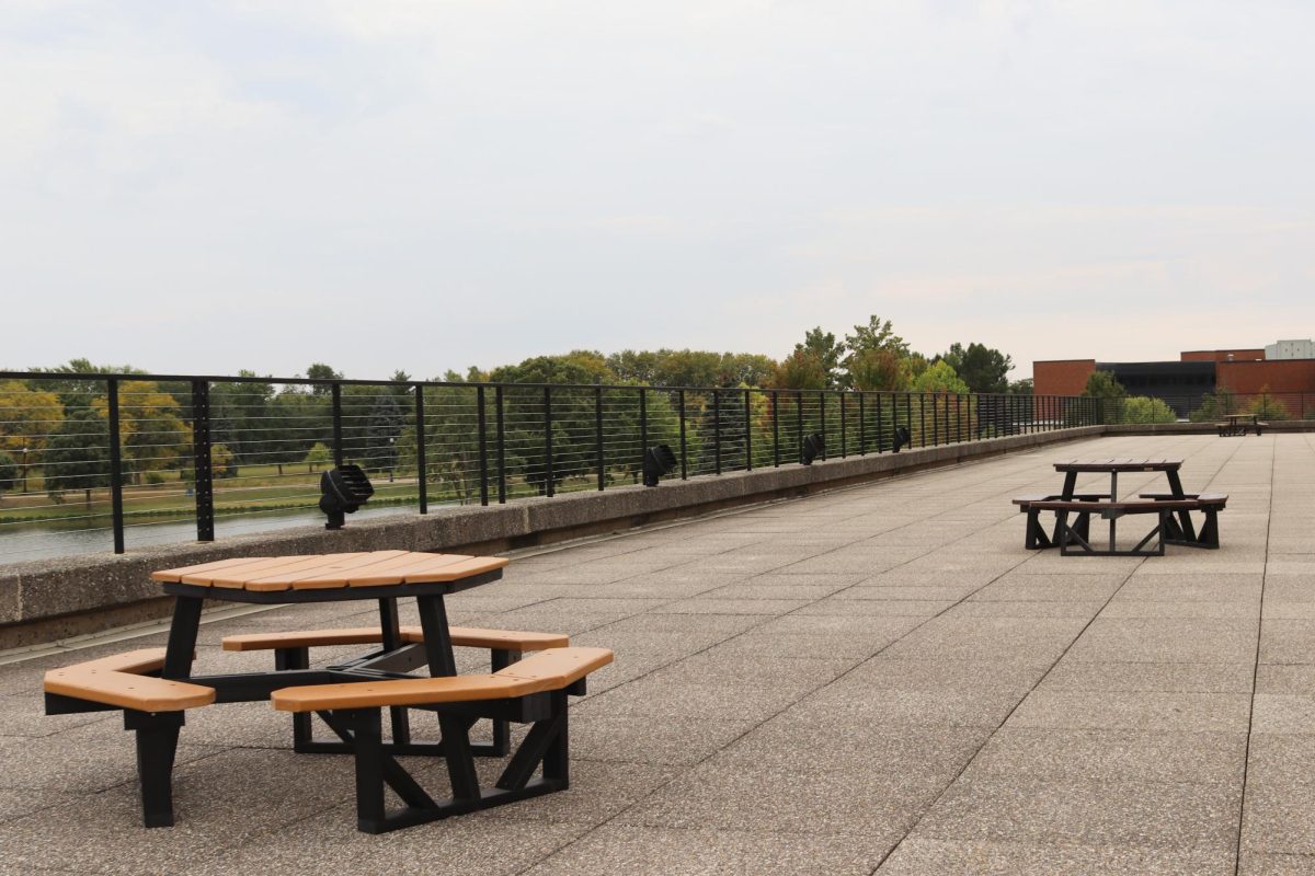 Hexagonal tables placed on the outer rooftop of Building B, on September 19, 2025. The tables are accessible by indoor and outdoor stairs and overlook the pond near the ECC campus.