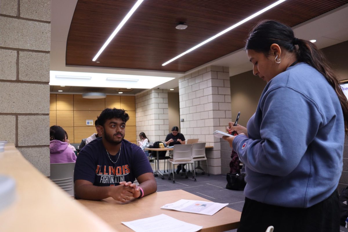 First semester Industrial Engineer Student Josiah Matthews discusses how he enjoys the challenges that come with complex math problems with staff writer Viviana Avila. Photo Taken in the D building Hallway