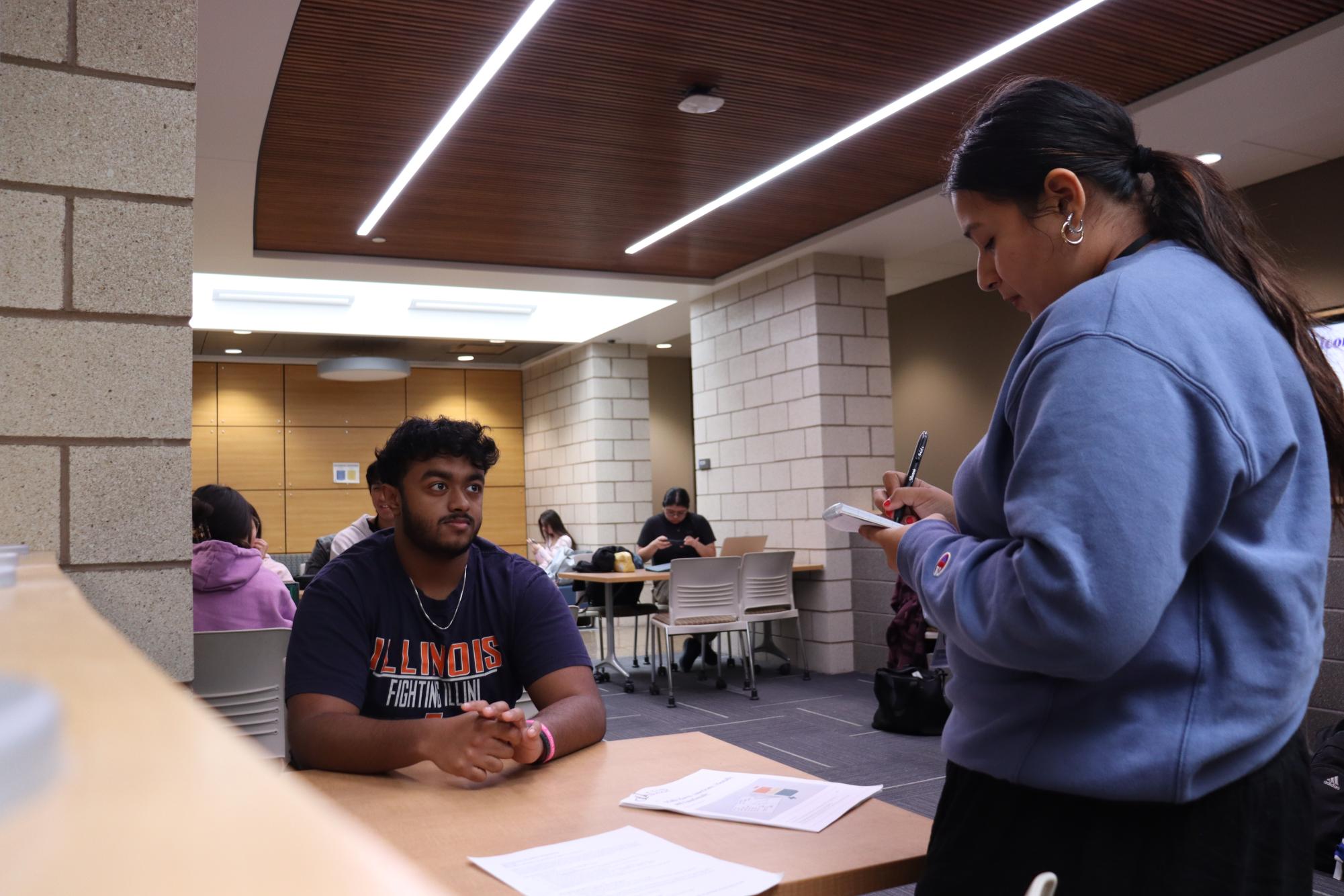 [File photo] First semester Industrial Engineer Student Josiah Matthews discusses how he enjoys the challenges that come with complex math problems with staff writer Viviana Avila. Photo Taken in the D building Hallway