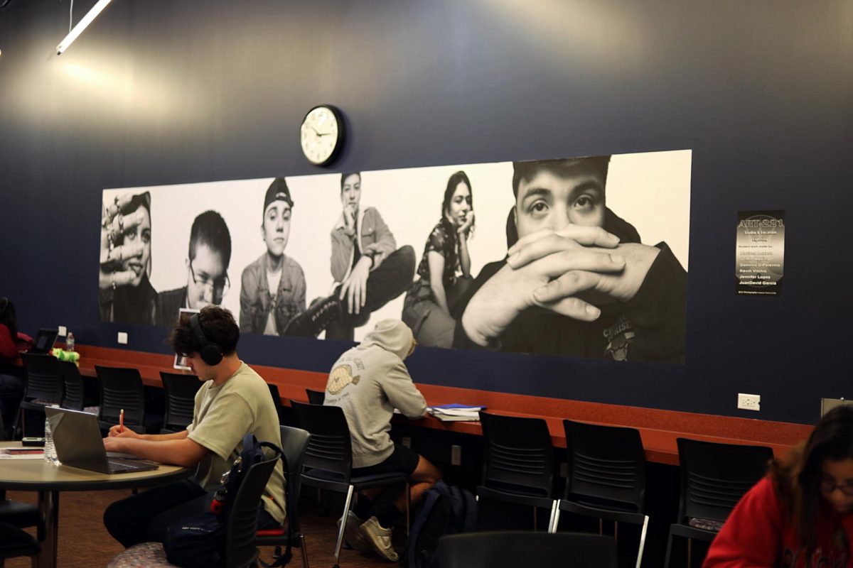 Locations of where art can be found around campus: Jessy Severing, Albin Romandi, and Brennan Coyle work on school assignments in a student lounge area in Building B where there is art-print on the wall on September 4th, 2025. 