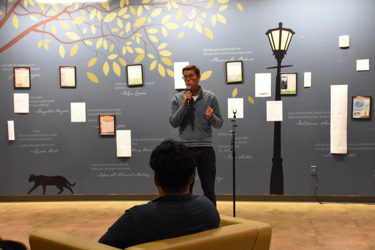 ECC Associate Professor of English, Joshua Thusat, recites some of the poem, "The Eagle" by Alfred Lord Tennyson at Coffee House with the Writer's Center. The event was an opportunity to highlight students' creative works in fiction, poetry and scripts. 