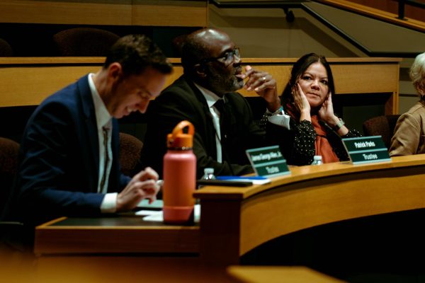 Trustee Barbosa-Guzman watches another Trustee speak in the Siegle Auditorium.