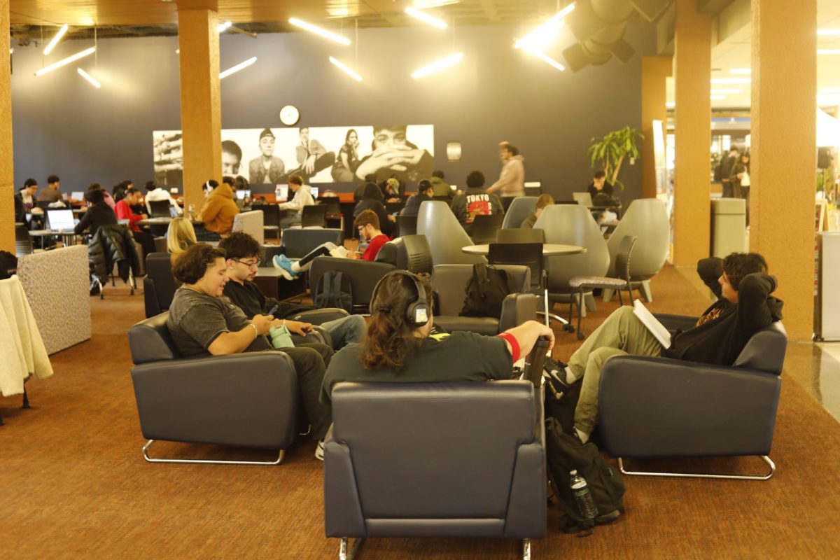 Students relaxing in blue chairs.