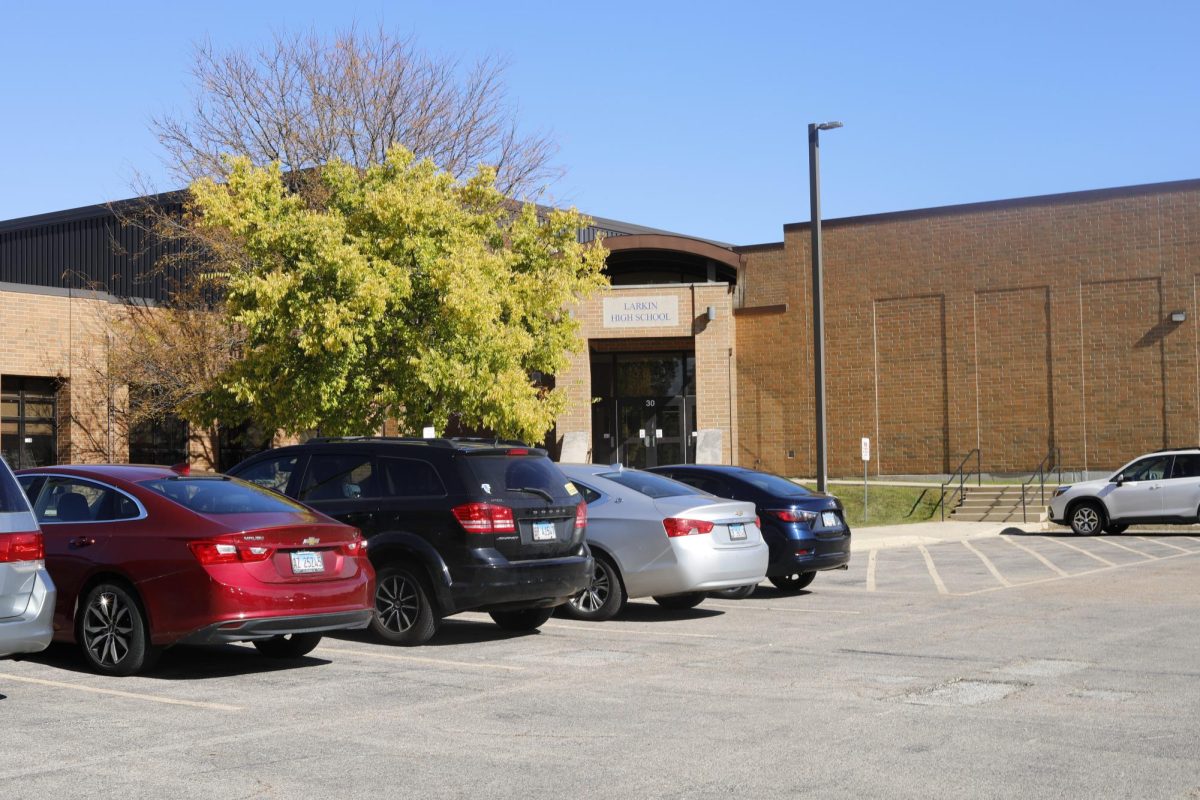 Parked cars in front of a back entrance to Larkin High School.