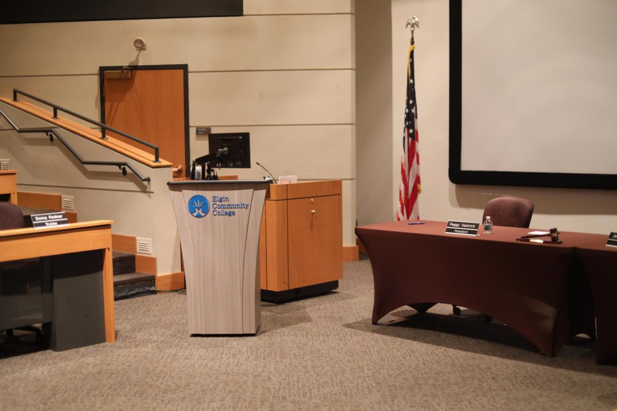 A podium, an American flag and a table.