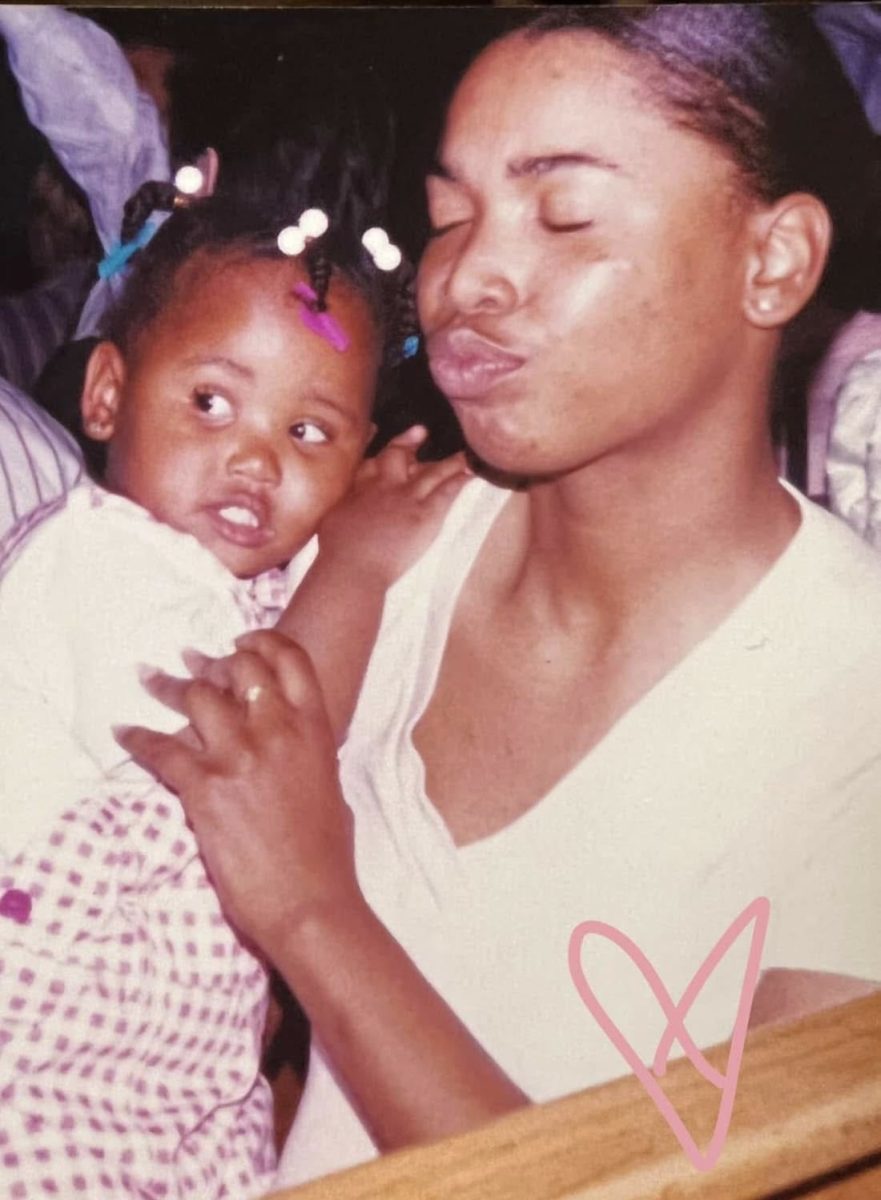 De'Shawn James, three, lies on her mother's shoulder while at a relative's house in 2003. James, now 25, laid her mother to rest this fall. Her mother died from domestic violence.