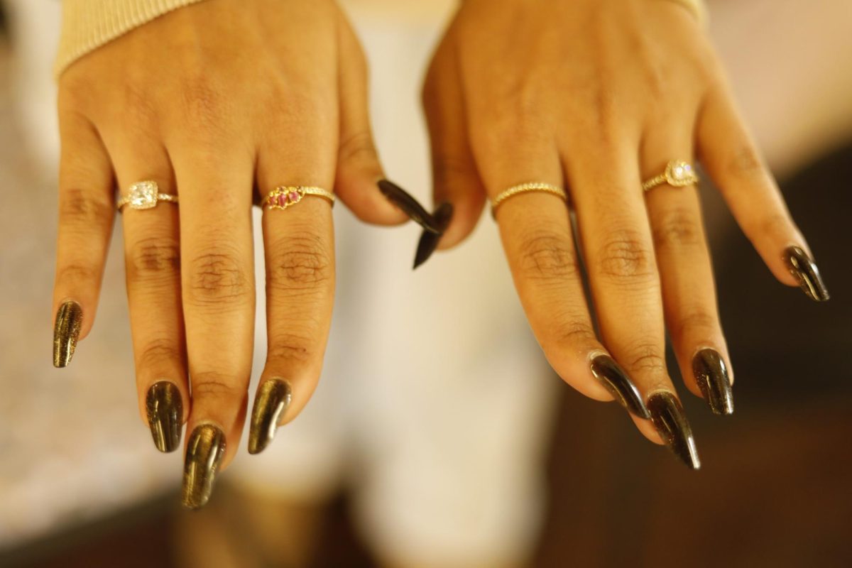 An ECC student displays her nails. But, nursing students are not allowed to have nails this length due to the nursing student handbook. This protocol is necessary for safety and sanitation reasons