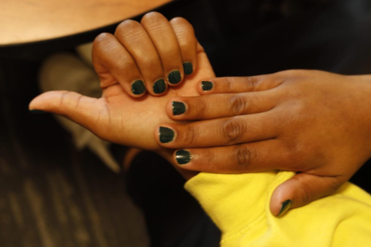 ECC student sports dark green nail polish. 